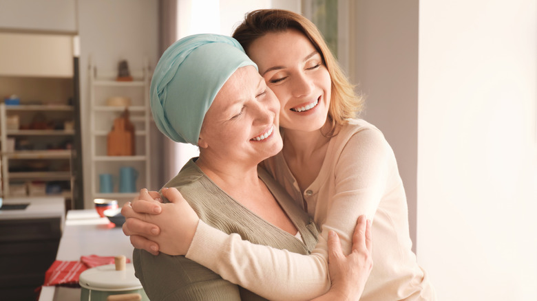 Woman visits her mother after cancer treaments