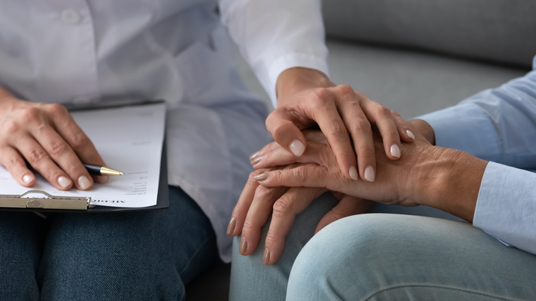 A doctor comforts a patient with cancer diagnosis