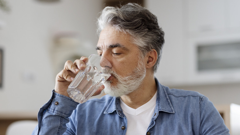 Man drinking glass of water