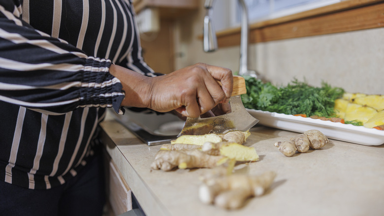 Lady chopping ginger