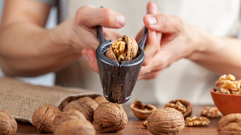 Hands cracking walnuts