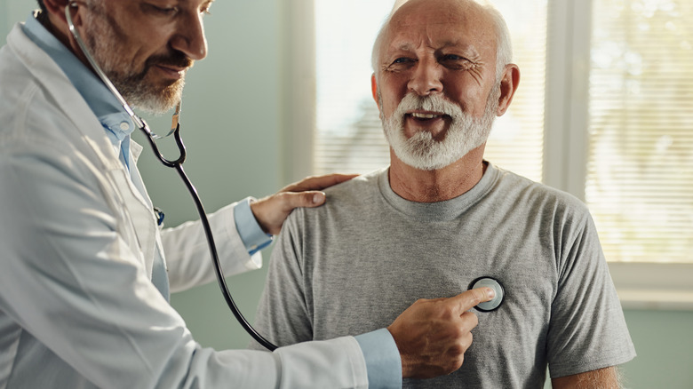 Doctor listening to patients heart