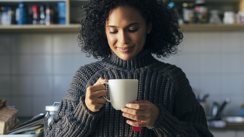 woman enjoying a hot beverage 