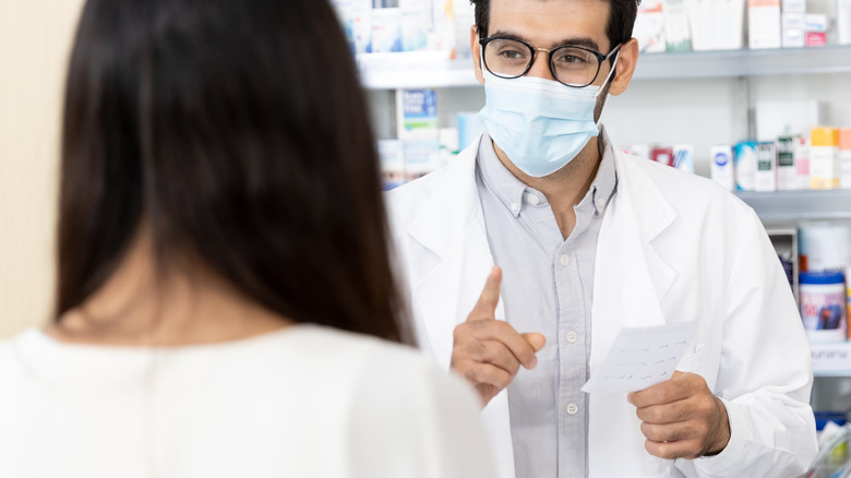 Pharmacist speaking to customer