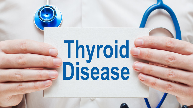 doctor holding up  'Thyroid Disease' sign