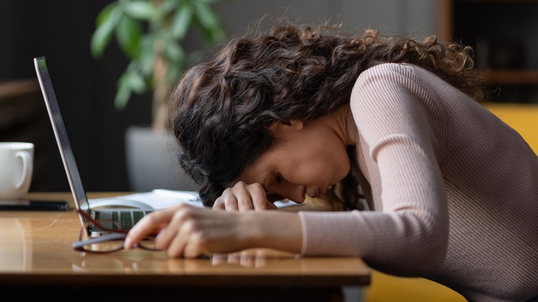 exhausted young female at work