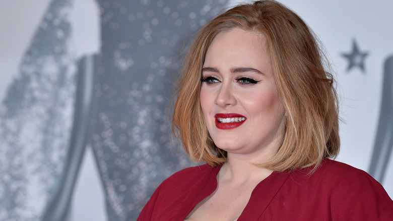 smiling Adele with red lipstick 