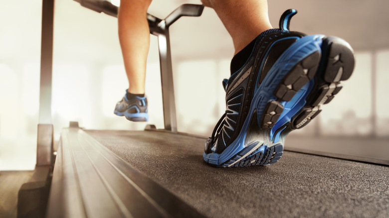 woman's feet running on treadmill