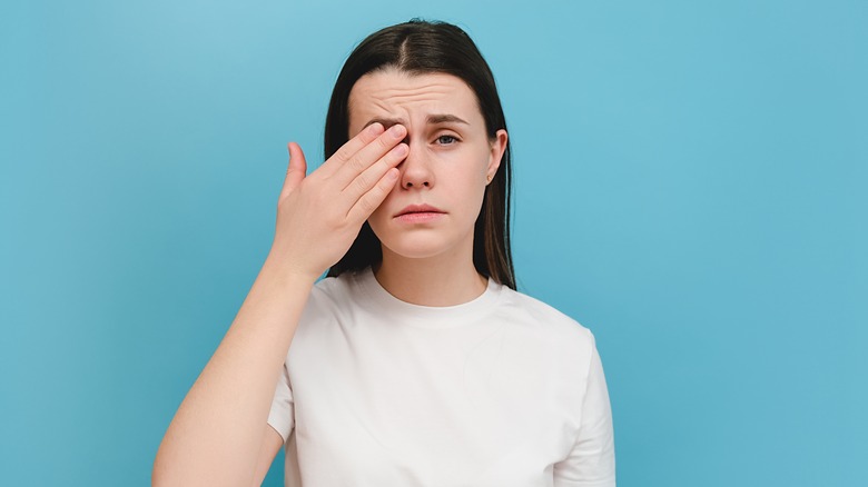 Woman in pain with eye infection