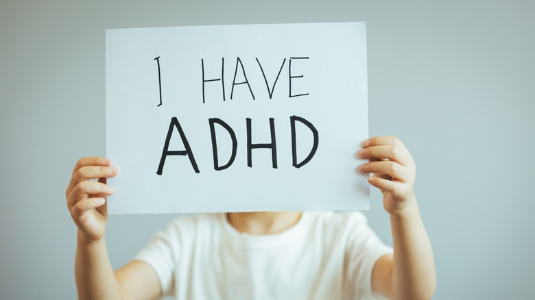 Boy holding an ADHD sign