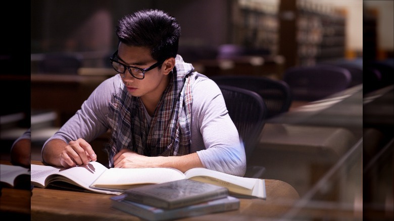 Male student studying in library