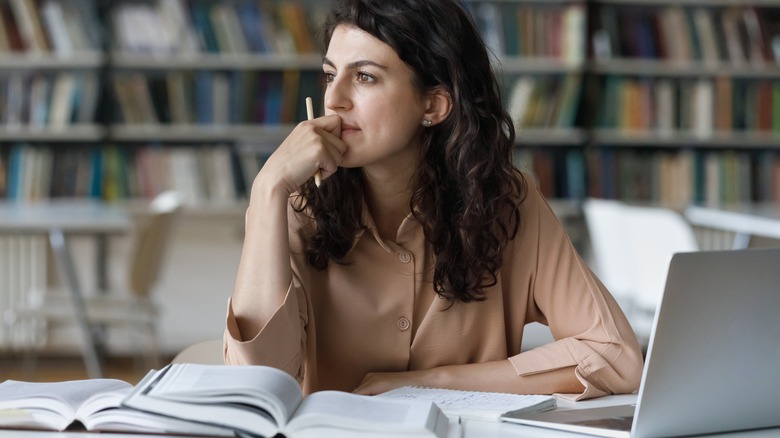 Woman at desk looking distracted