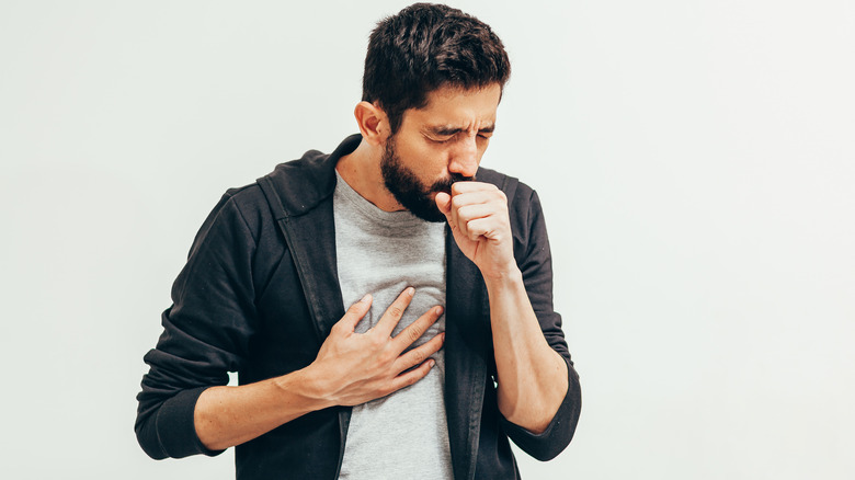 man coughing