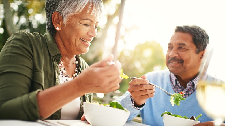 older couple eating salad