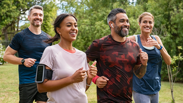 healthy men and woman jogging in the park