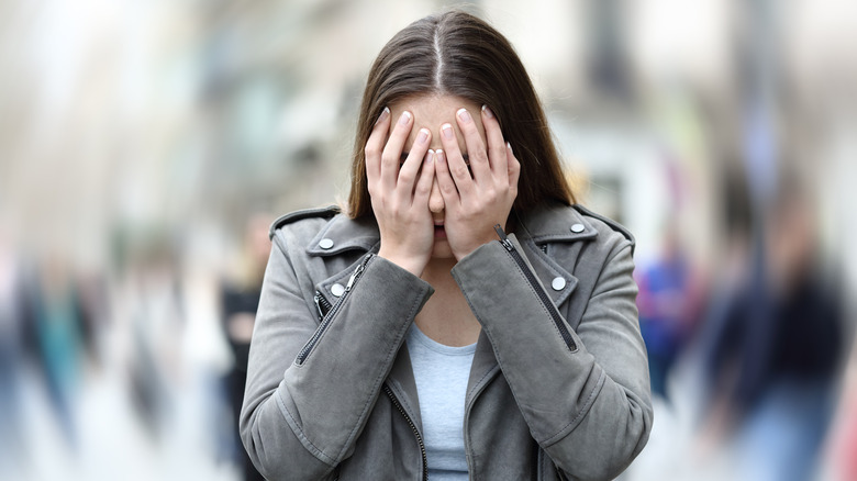 woman covering face