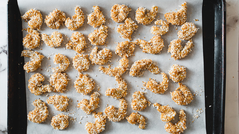 coconut shrimp on a baking sheet