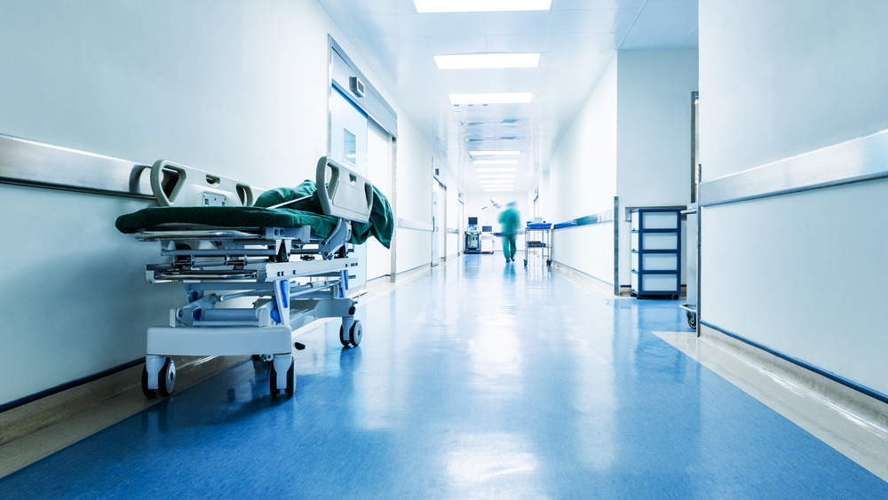 empty hospital bed in hospital hallway