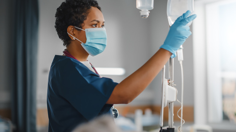 Nurse checking patient's IV drip bag