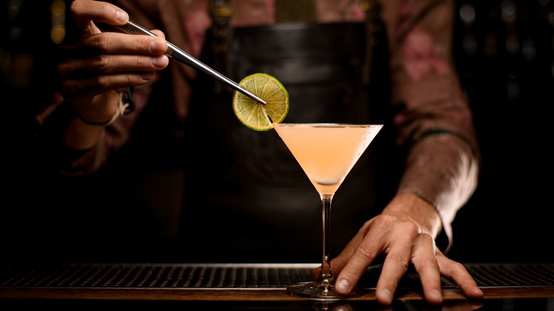 Dry martini being garnished by bartender