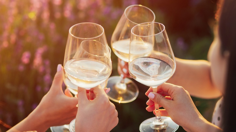 friends toasting white wine glasses