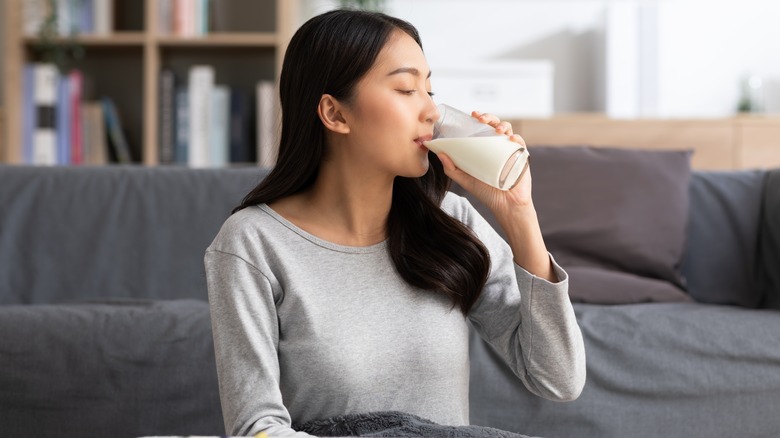 young asian woman drinking milk