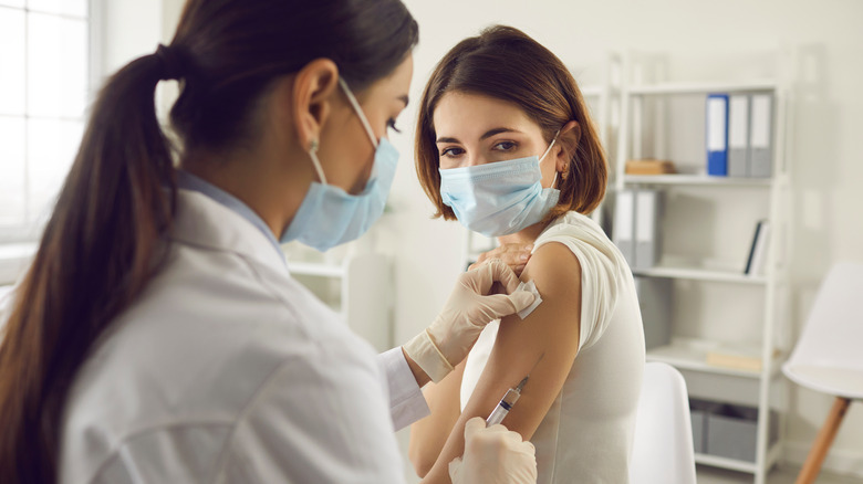 female doctor administering a vaccination