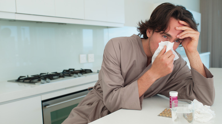 sick man taking medicine