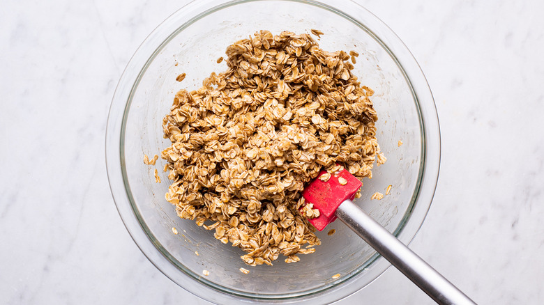 granola mixed in glass bowl