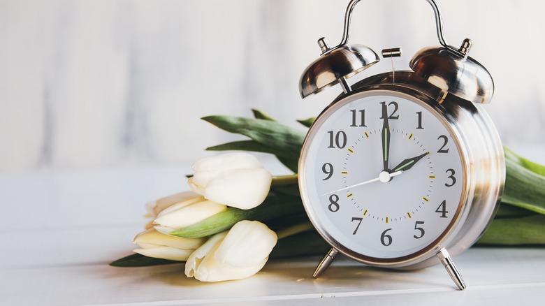 Silver clock with white tulips