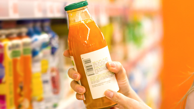 woman holding bottle of juice