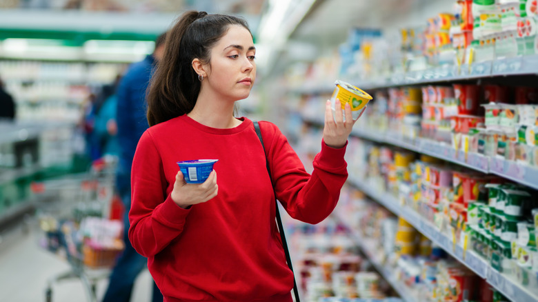 woman comparing yogurts