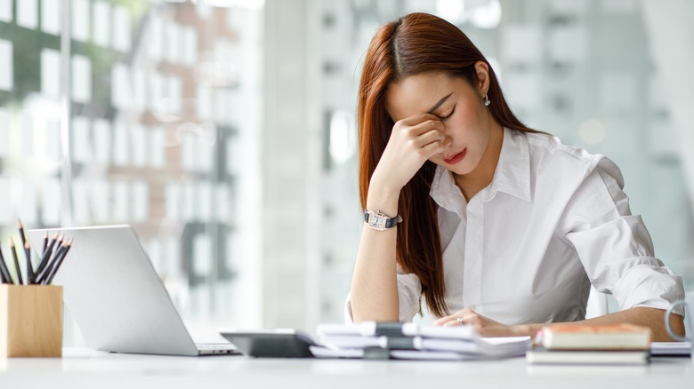 young asian woman looking stressed