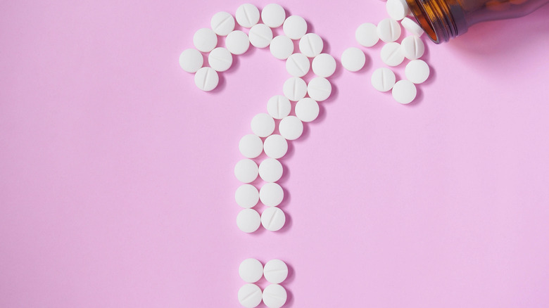 medication tablets forming question mark