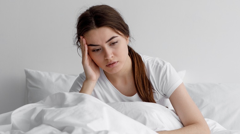 woman in bed feeling depressed