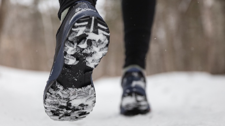 close-up of runner's shoes in the snow