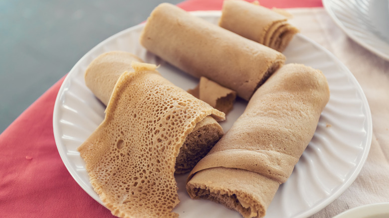 Several pieces of rolled injera bread