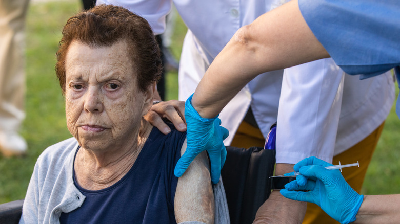 Older woman receiving a vaccine