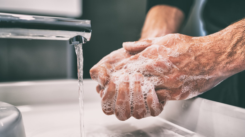 Close up of man washing his hands