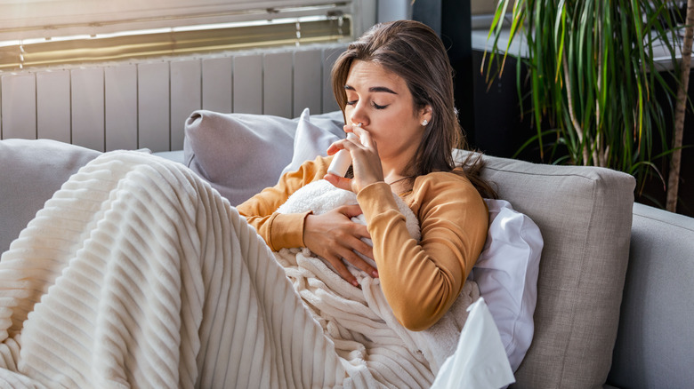 woman using nasal spray