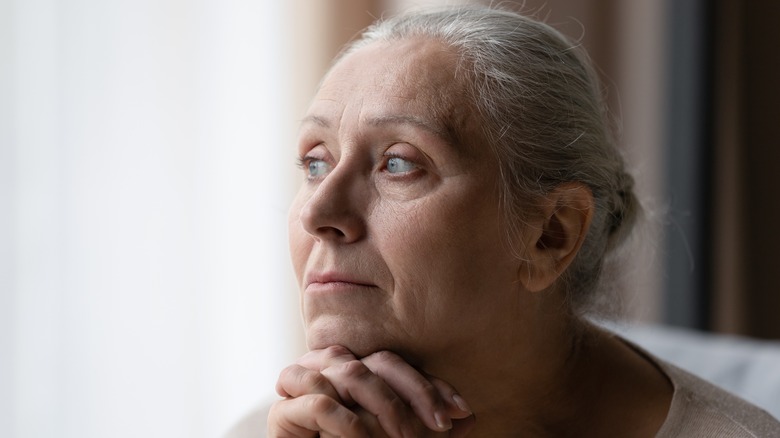 Woman resting chin on hands