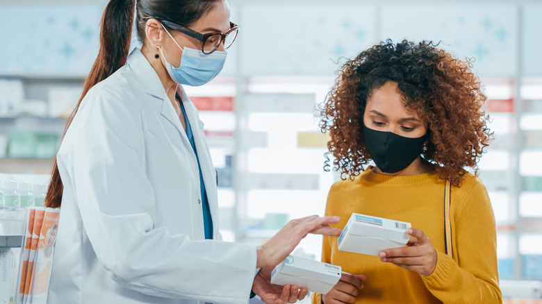 Doctor and patient examining medication