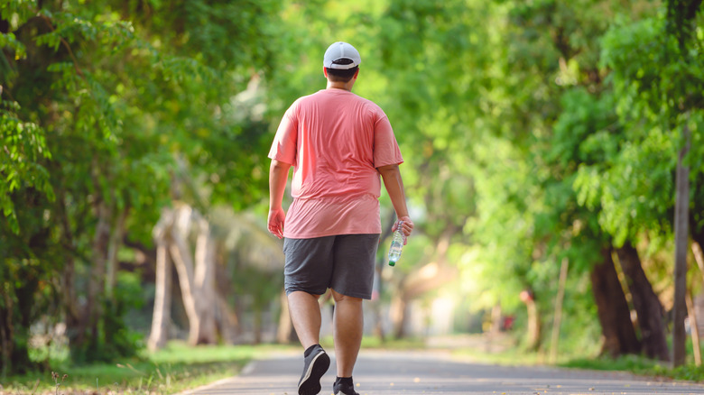 Man walking on concrete road