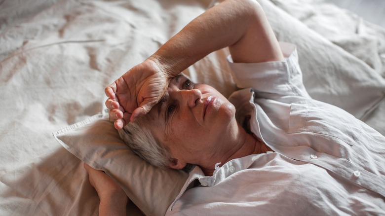 older woman awake in bed 