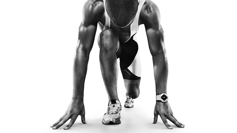 Black and white image of runner at the starting line