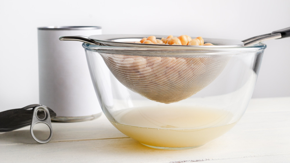 Canned chickpeas in a strainer over a bowl