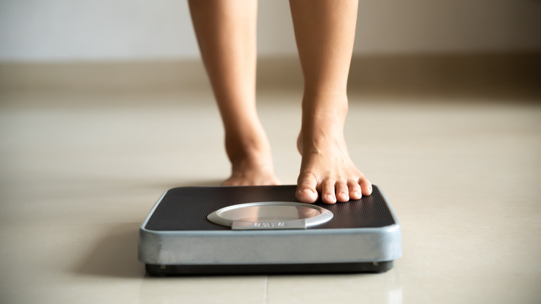 Person stepping onto scale