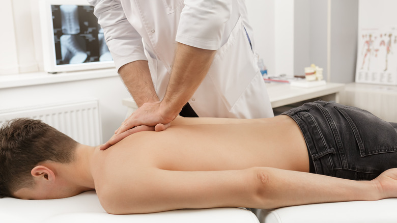 chiropractor working on male patient