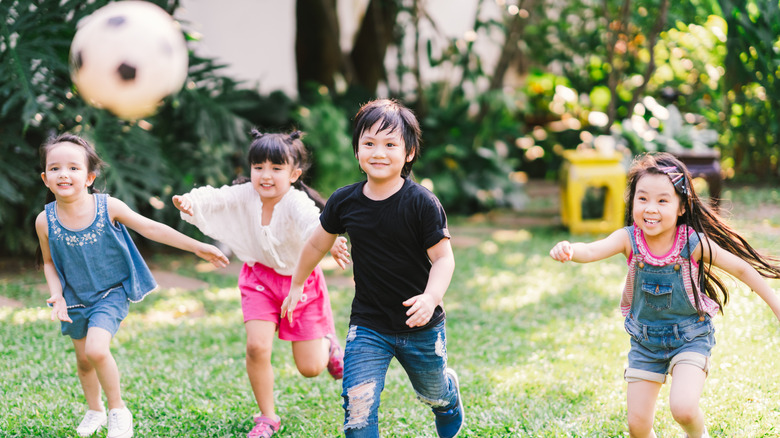 Group of smiling children playing soccer