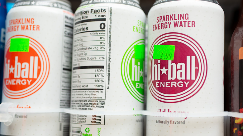 Close up on label of 3 cans of Hi-ball sparkling energy water